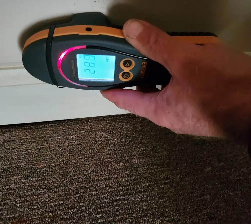 Moisture detection at baseboard during Storm Damage Restoration in Wichita